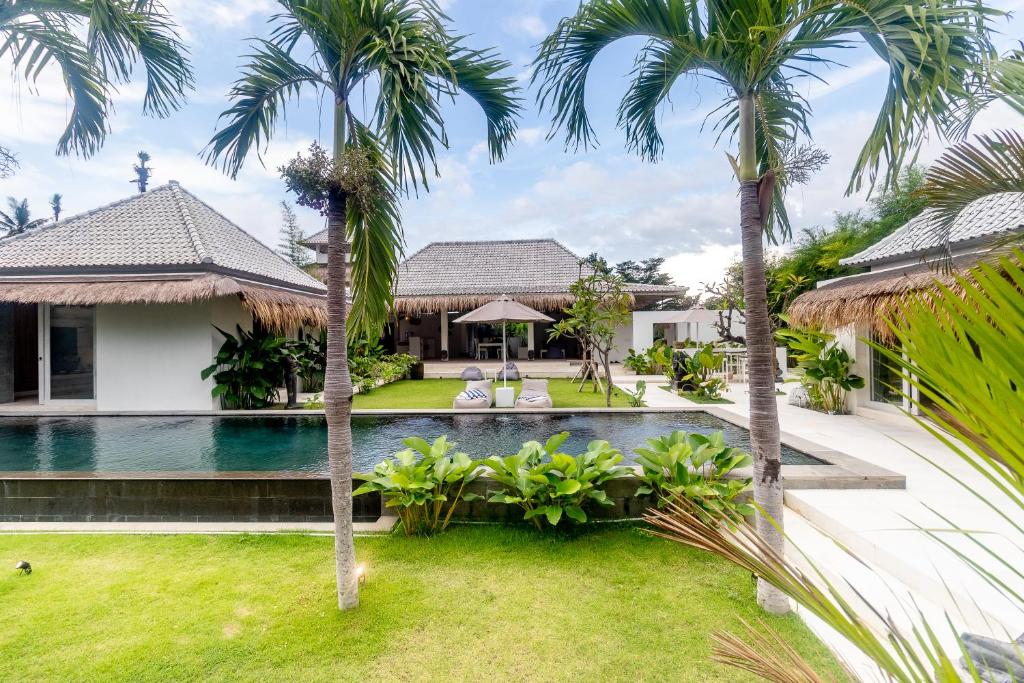 an image of a villa with a swimming pool and palm trees at OMAÏA Private villas in Amed
