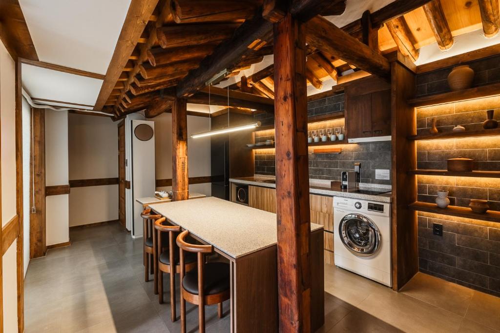 a kitchen with a counter and a washer and dryer at Luxury Hanok MOOD-AM in Seoul