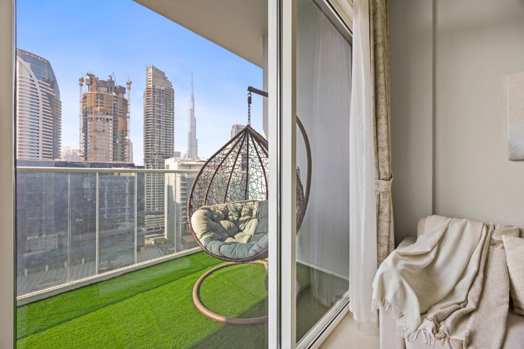 Hotel Burj khalifa and Canal views - Luxury Apartments for Rent in Dubai Business Bay, a room with a hammock on a window with a view at Burj khalifa and Canal views - Luxury Apartments for Rent in Dubai Business Bay in Dubai