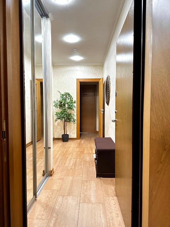 a hallway with a door and a plant in it at PhucAn Shared-Apartment in Riga in Riga