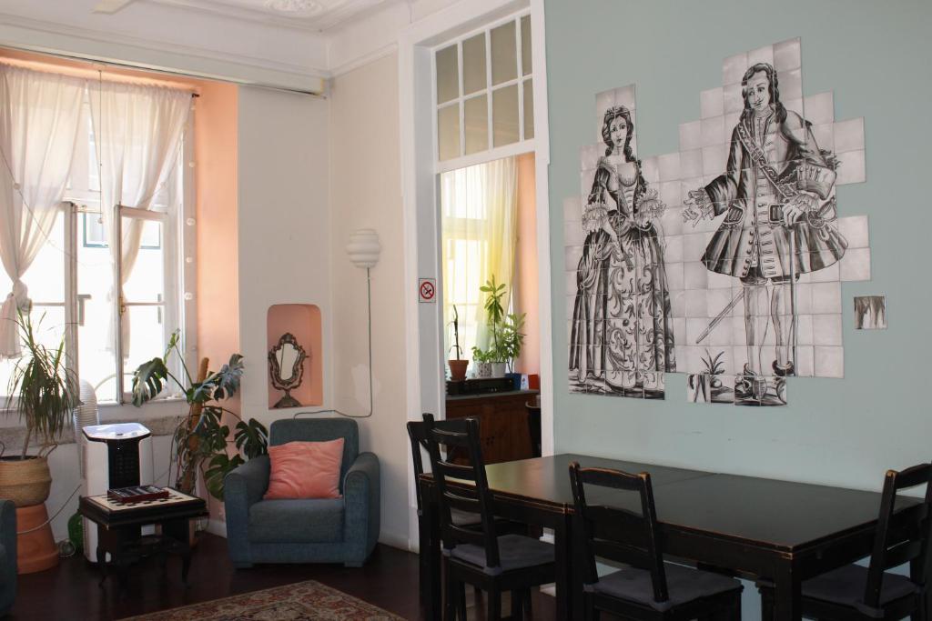 a living room with a table and a chair at Rossio Hostel in Lisbon