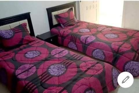 two beds sitting next to each other in a bedroom at Bardo centre in Tunis