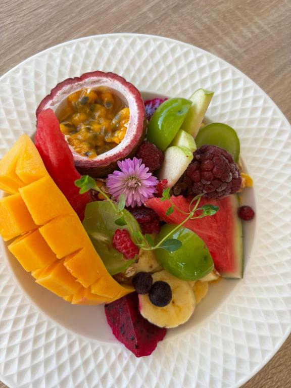 a plate of fruit and vegetables on a table at Sunrise Brunch & Stay in Pai