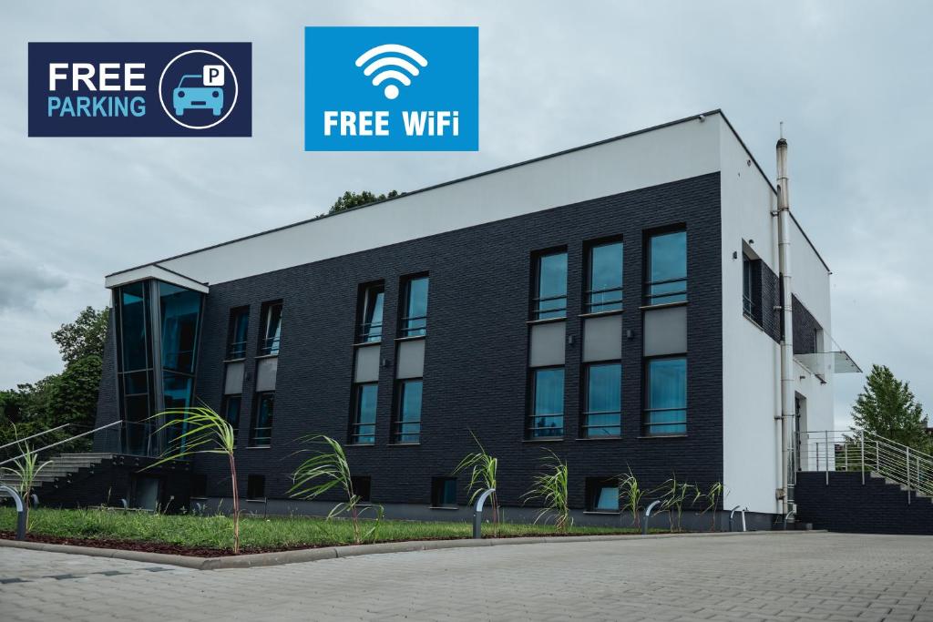 a building with a sign that reads free wifi at Apartamenty Janasa 13 in Chorzów