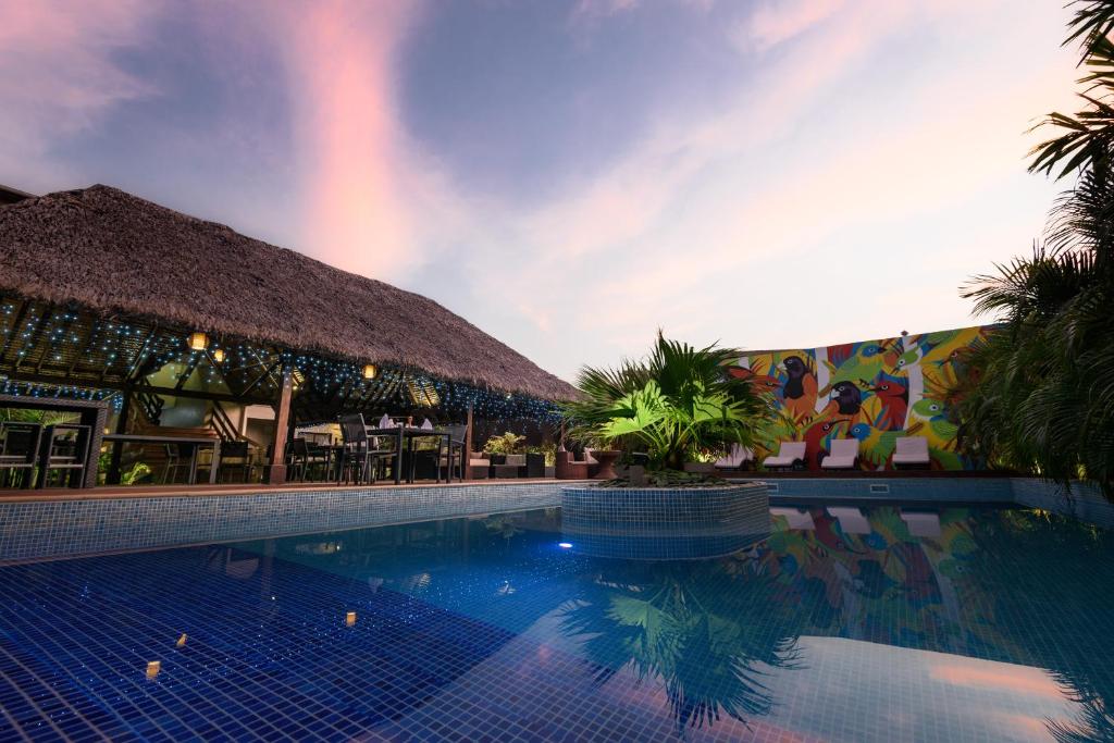 a pool at a resort with a rainbow in the sky at The Espiritu in Luganville