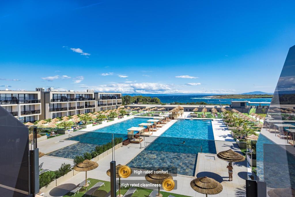 a view of the pool at a resort with umbrellas at Residence Del Mar Emotion in Pula