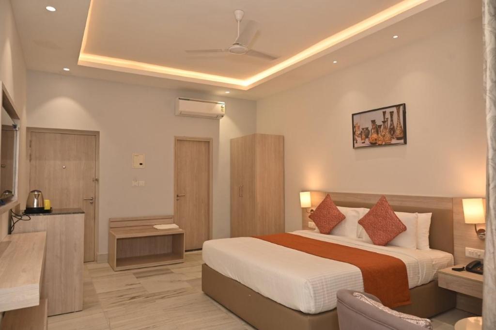 a hotel room with a bed and a bathroom at Poonam Aayati in Varanasi