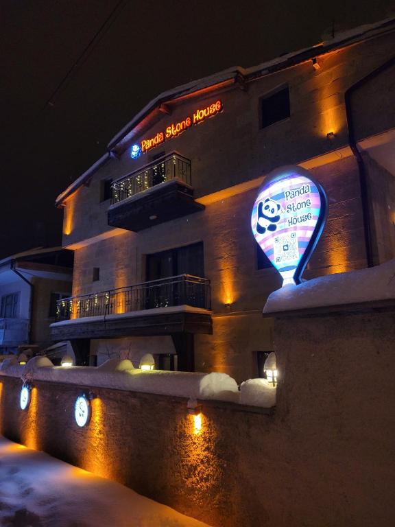 a building with a sign in front of it at night at Panda Stone House in Nevşehir