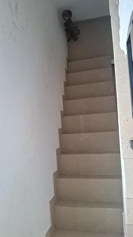 a staircase with a ceiling fan in a room at Sea view villa 3 in Kāsaragod