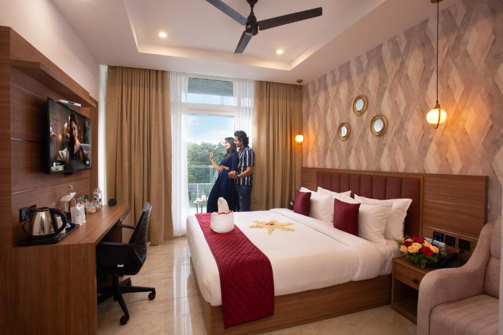 two people are standing in a hotel room at The Grand Sanvika in Ramakkalmedu