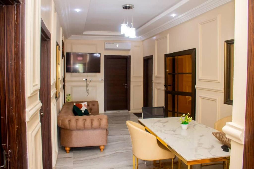 a living room with a table and a chair at KapeView Elegant Suite in Cape Coast