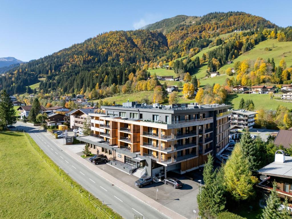 an aerial view of a building in the mountains at AlpenParks Hotel & Apartment Taxacher in Kirchberg in Tirol