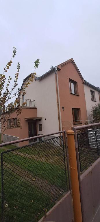 a house with a fence in front of it at Ubytování Lipová in Jihlava