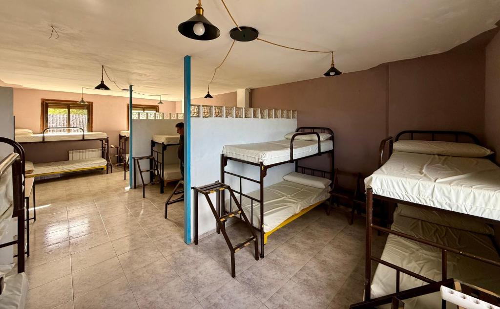 a room with several bunk beds in a room at Meson el Acebo in El Acebo de San Miguel