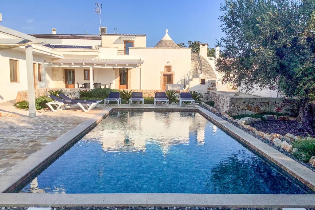 een zwembad voor een huis bij Villa with Trullo and Pool, Alberobello in Alberobello