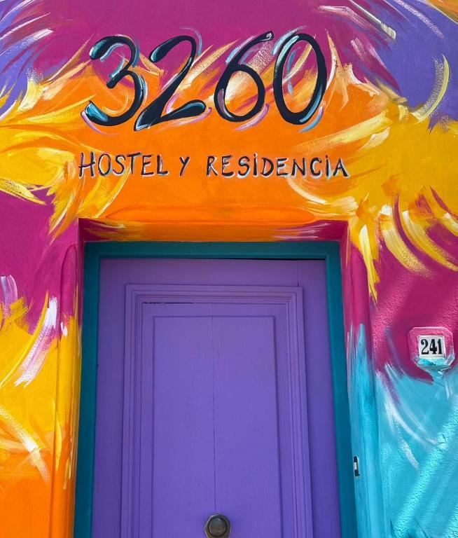 a neon sign over the door of a house at 3260HOSTEL in Concepción del Uruguay