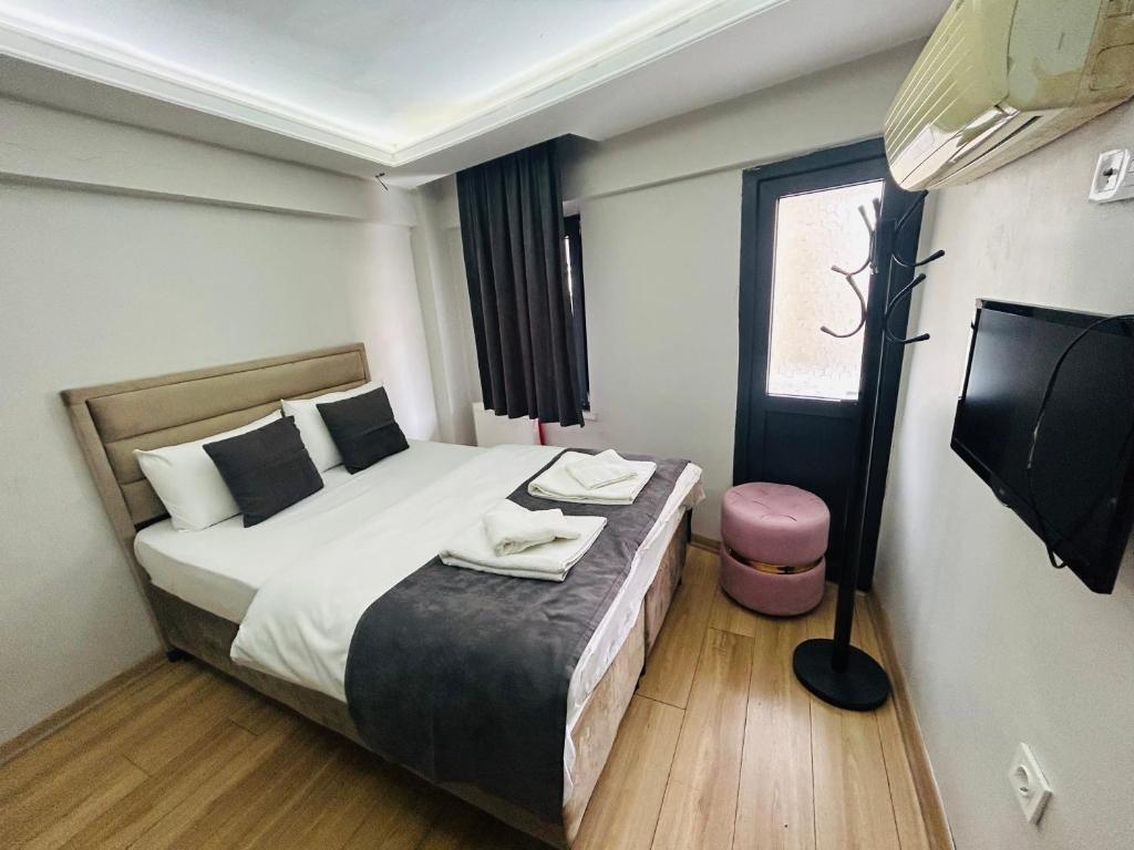a hotel room with a bed and a tv at Mesil Hotel in Istanbul