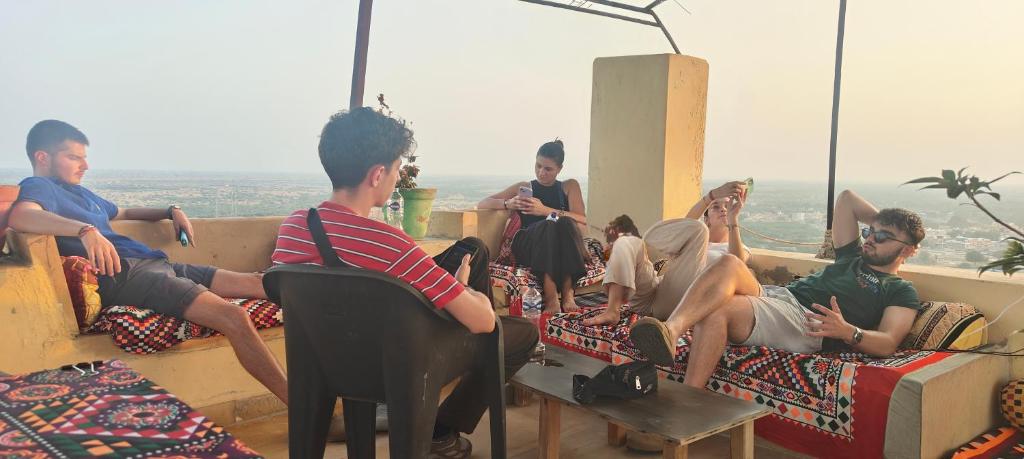 a group of people are sitting on beds at Hotel Nomadic Haveli in Jaisalmer