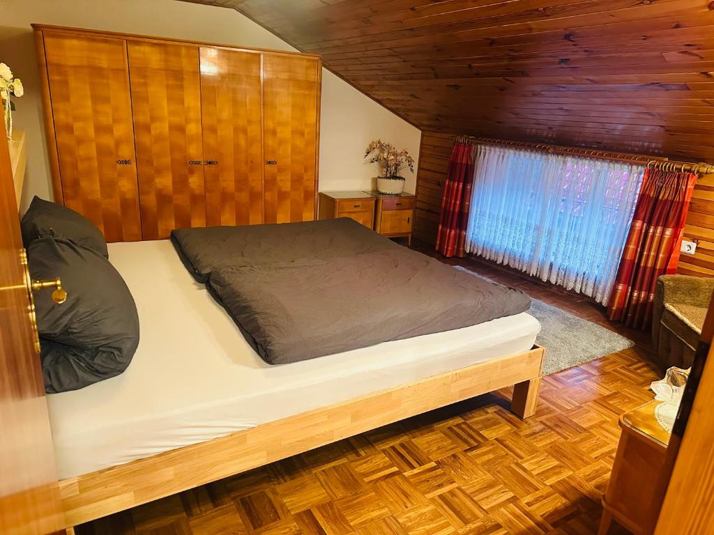 a bedroom with a bed in a wooden cabin at Ferienwohnung Marie in Kurort Steinbach-Hallenberg
