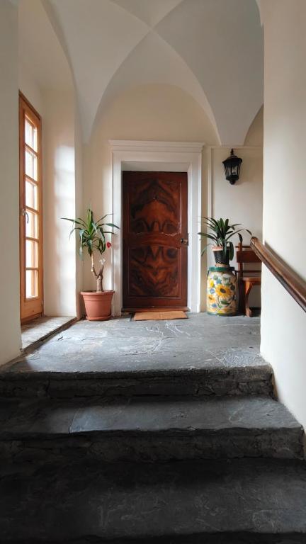 a hallway with a wooden door and potted plants at Maison Brunet in Aime La Plagne