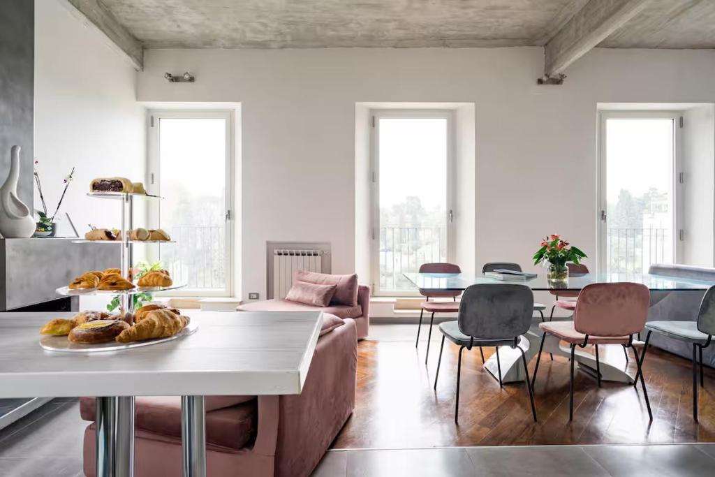 a living room with a table with a plate of bread at Comfortable Lux apartments near the Colosseum - Rome in Courmayeur