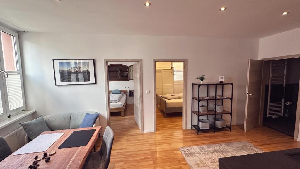 a living room with a table and a dining room at Heimatliebe Erfweiler Wohnung ÄNS in Erfweiler
