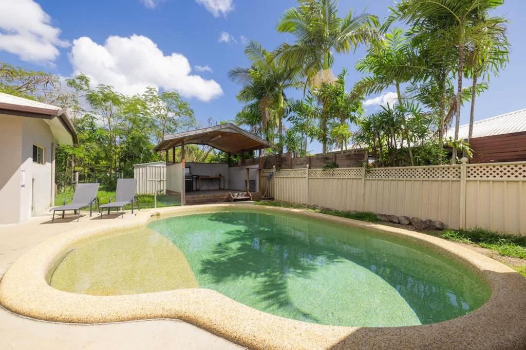 a swimming pool in the backyard of a house at Seednest 7 bedroom beach house Pool &Game Room in Kewarra Beach