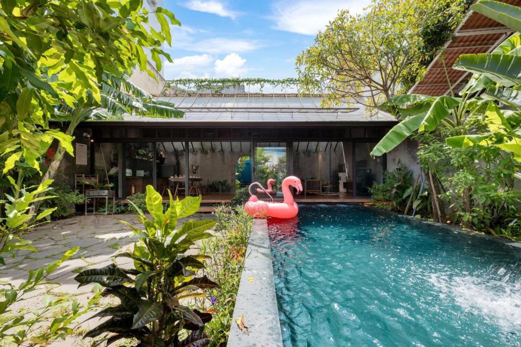 a pool with a pink inflatable flamingo in a backyard at AN Village 1 in Vung Tau