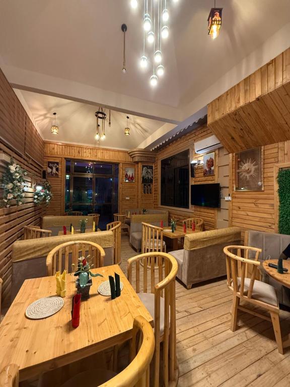 a restaurant with a wooden table and chairs at Kasai in Dodoma
