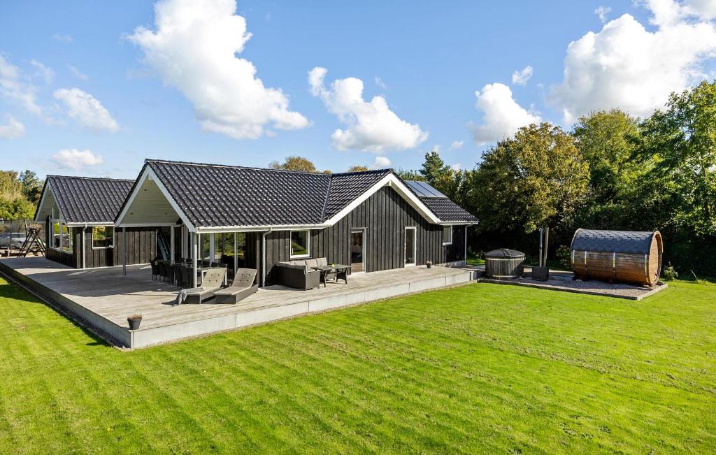 a house with a large backyard with a lawn at Lovely Home In Gørlev With Sauna in Reersø