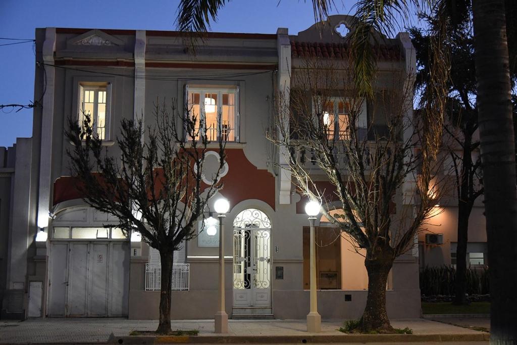 a house with two trees in front of it at Altos Yrigoyen Hotel in Marcos Juárez