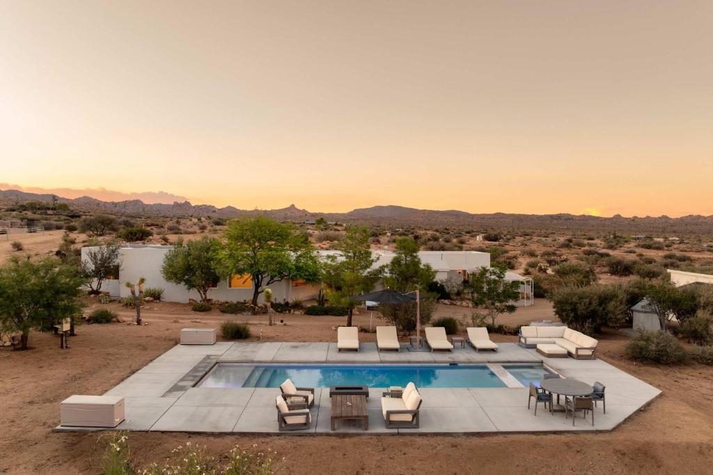 een buitenzwembad met ligstoelen en een tafel bij La Grange by The CoHost Company in Rimrock