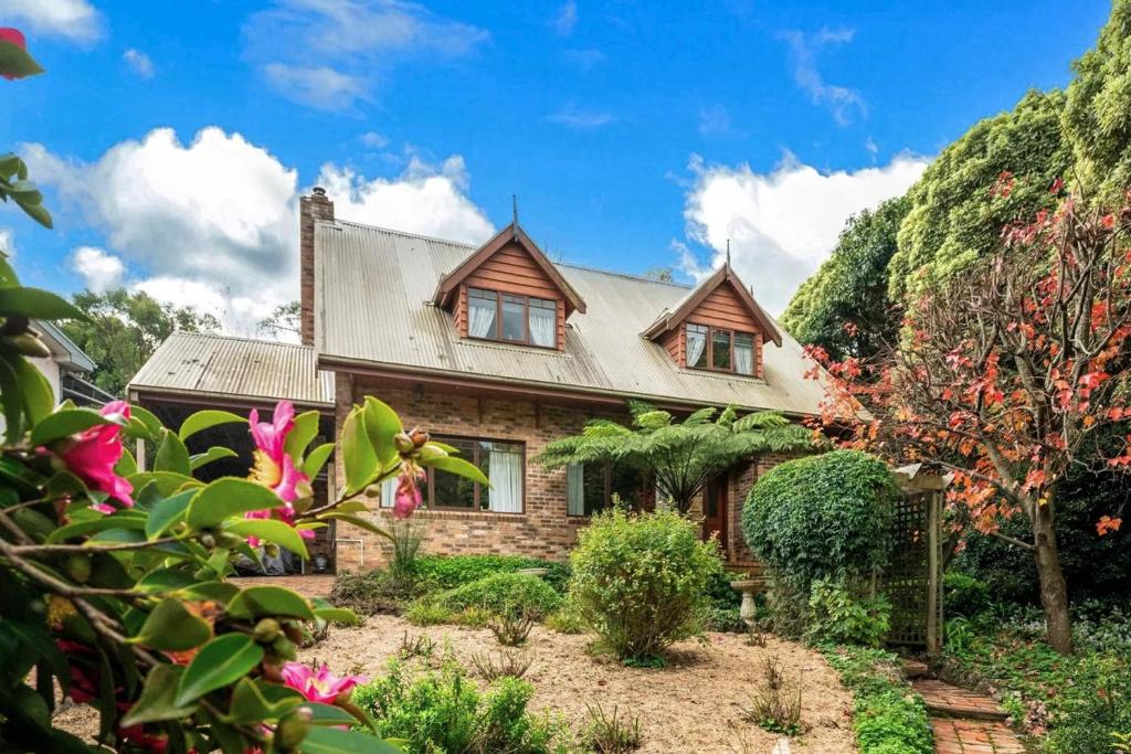 a stone house with a roof at The Tolpuddle Cottage in Warburton