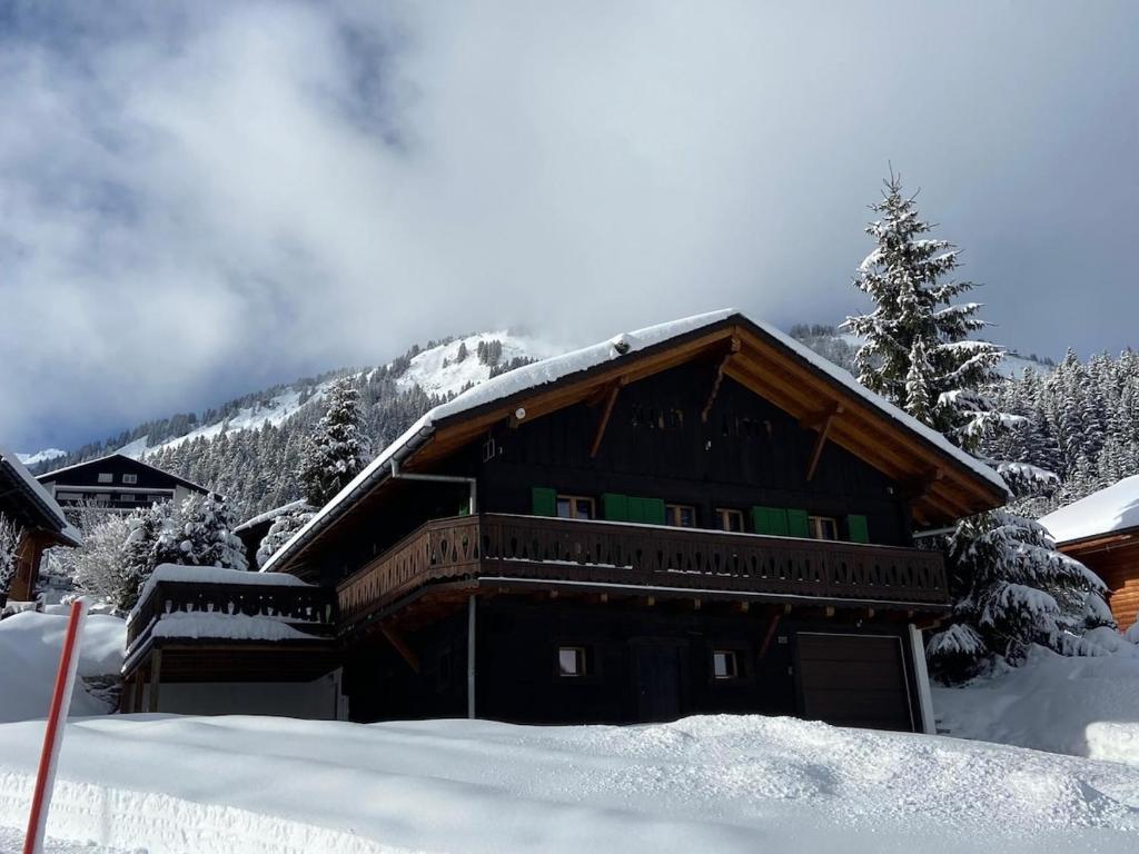a snow covered cabin with a snow covered roof at Chalet Les Ravaires, Morgins in Troistorrents