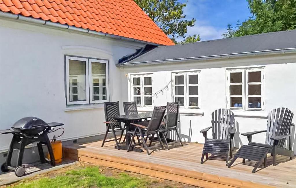 a patio with a table and chairs and a grill at Beautiful Home In Ærøskøbing in Bro