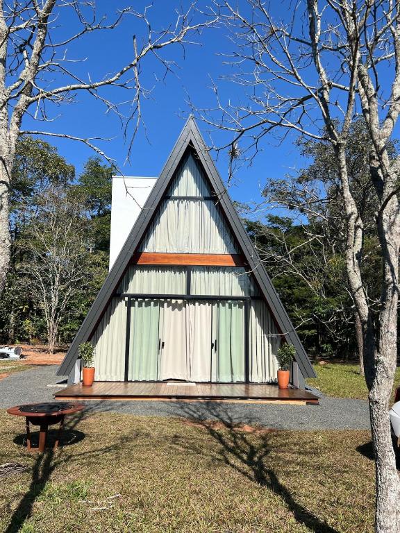 a small white building with a triangular roof at Chale Blue Lodge in São Pedro