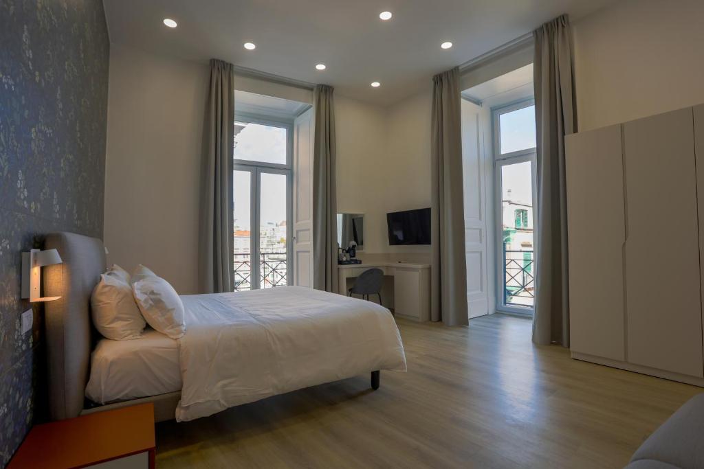a bedroom with a bed and sliding glass doors at Elysium Relais in Naples