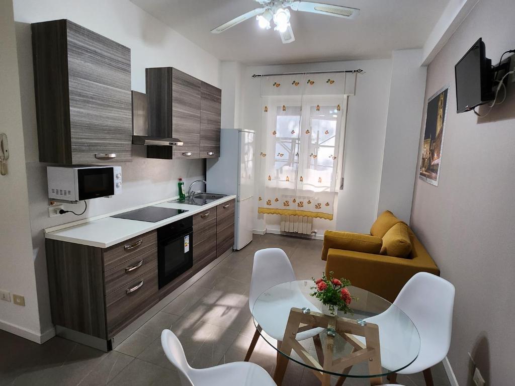 a kitchen and living room with a table and a couch at HB Appartamenti in centro Bergamo in Bergamo