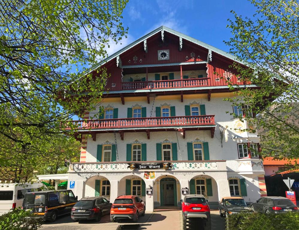 a large building with cars parked in front of it at ciao-aschau Haus zur Burg Ap108 Weber in Aschau