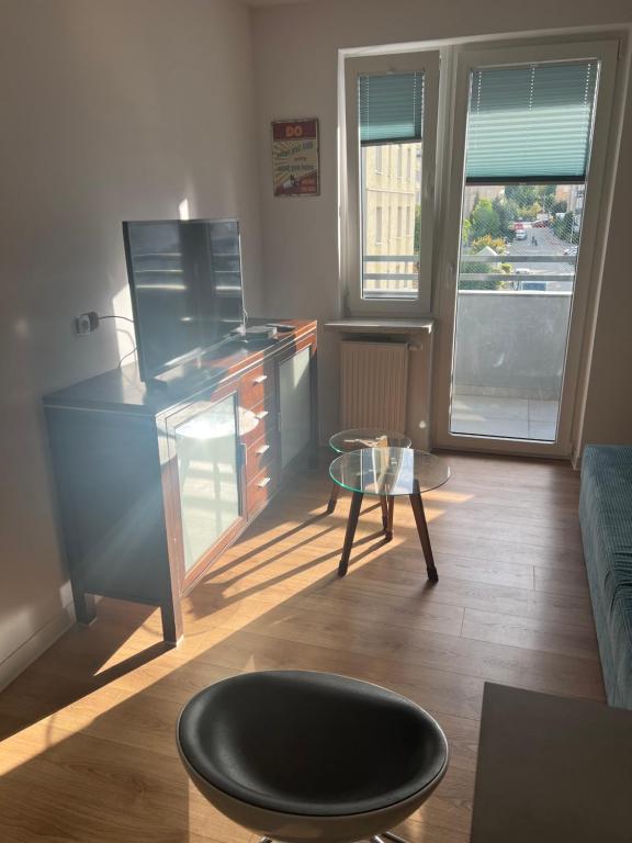 a living room with a desk and a table at Ruczaj Cozy Room in Krakow