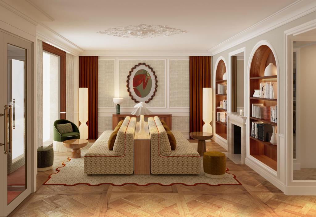 a living room with a couch and a table at Hôtel Almarine Eiffel by Malone in Paris