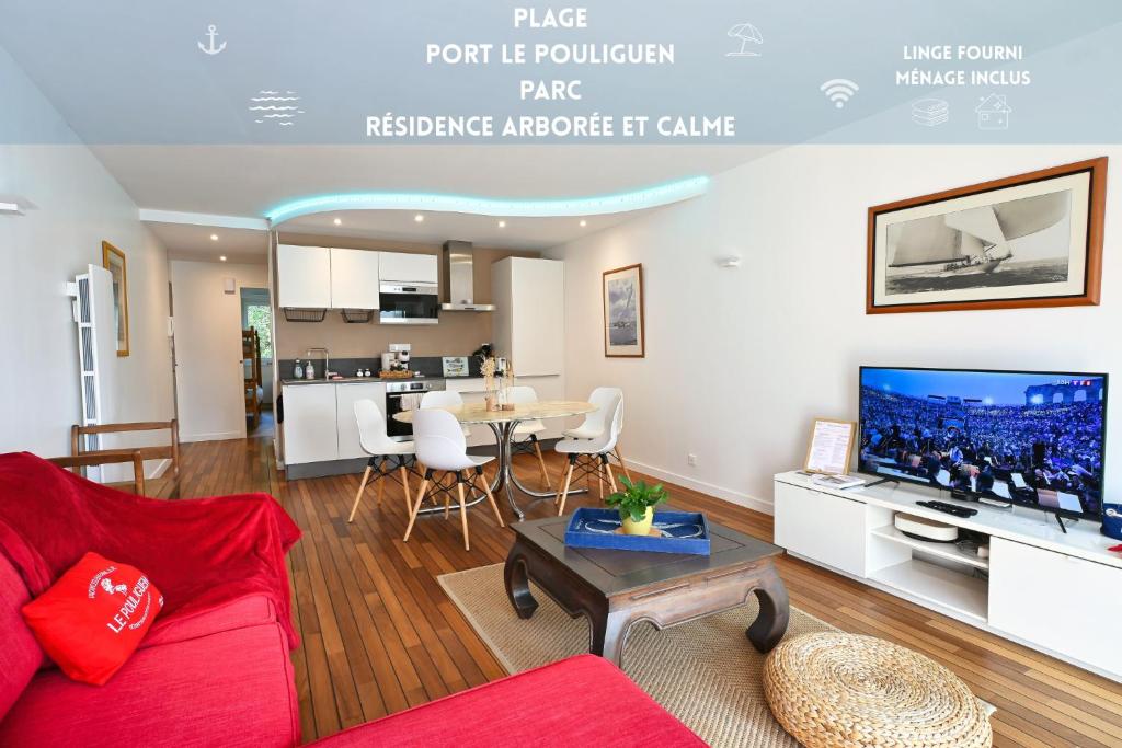 a living room with a red couch and a table at Le Navire-Plage du Nau-Parc-Résidence calme-Garage in Le Pouliguen