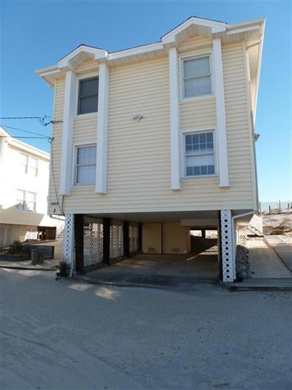 a large white house with a large garage at Holgate Ocean Front Duplex 2Nd Fl 14018 in Holgate