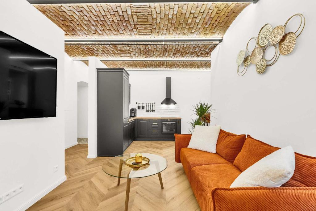 a living room with a couch and a table at The Magnificent Urban Hideaway in Vinohrady