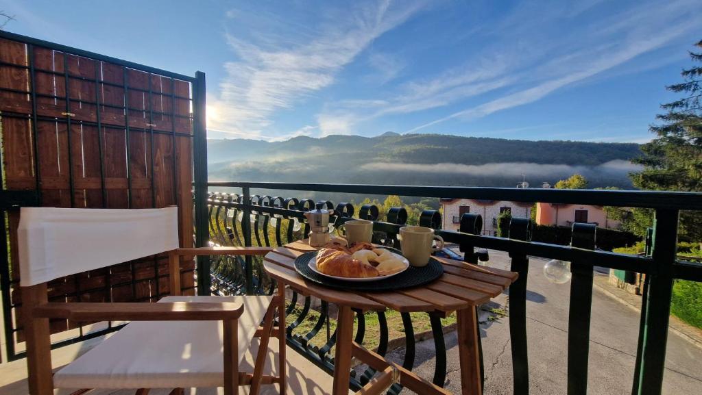 a table with a plate of food on a balcony at La casa di Maca in Ateleta