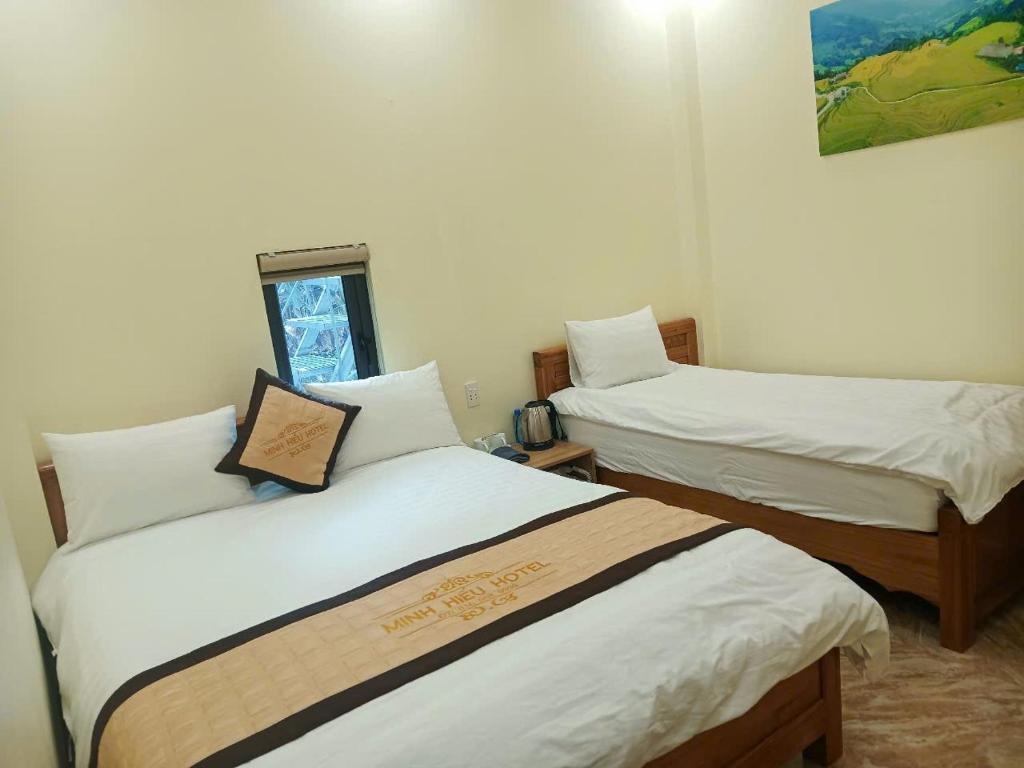 Postel nebo postele na pokoji v ubytování minh hieu hotel
