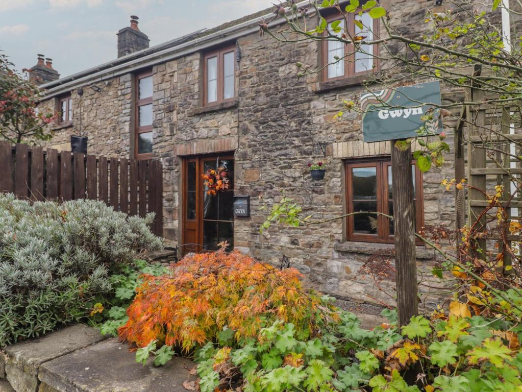 a stone house with a garden in front of it at Gwyn Studio in Aber-nant