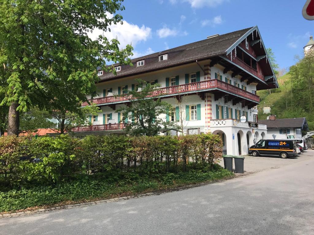 a large white building with a black roof at ciao-aschau Haus zur Burg Ap104 Pabst in Aschau