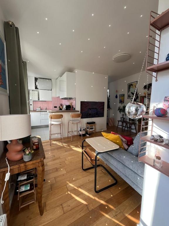 a living room with a couch and a table at Charming 2 room appartement in Paris