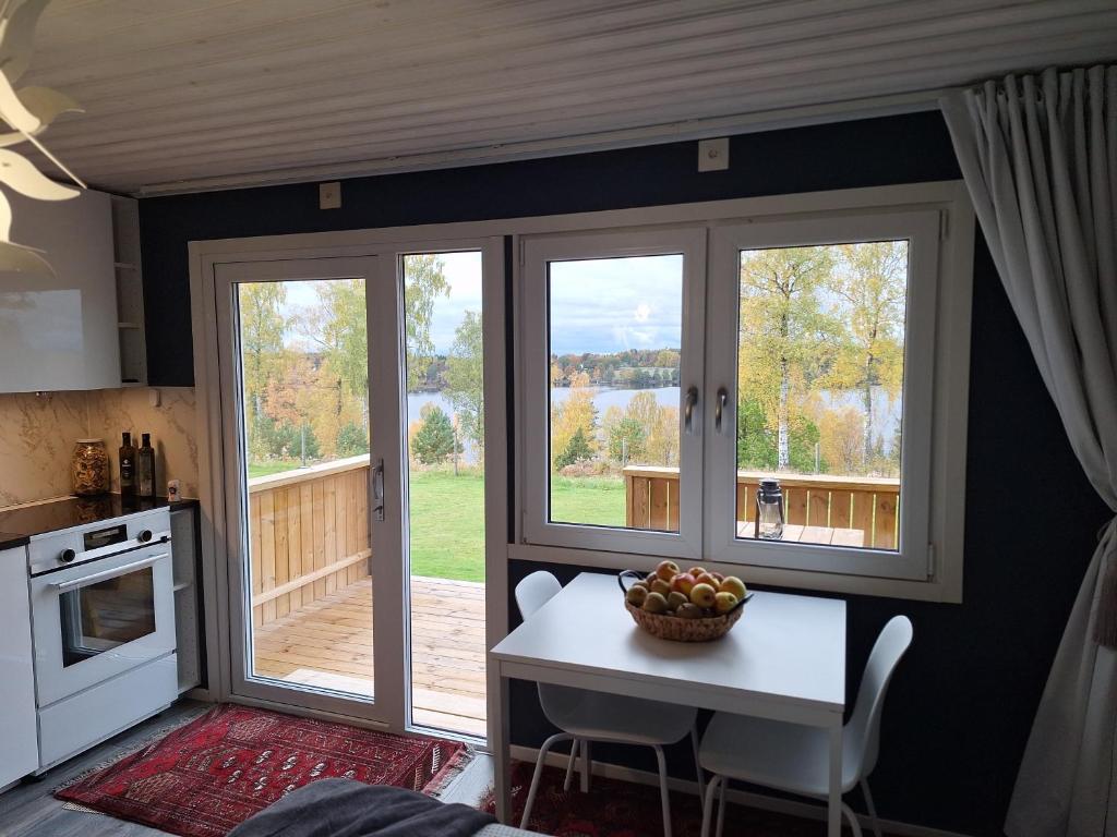 a kitchen with a table with a bowl of fruit on it at Tofta in Växjö